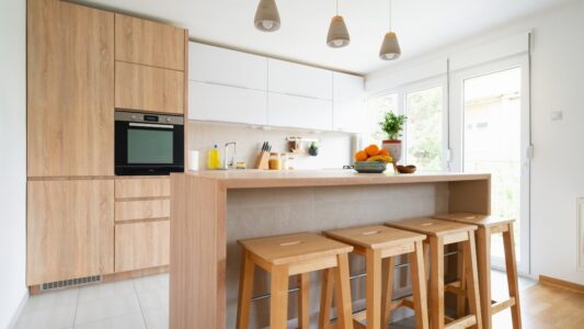 Residential cleaning team maintaining a bright modern kitchen before homeowner arrival